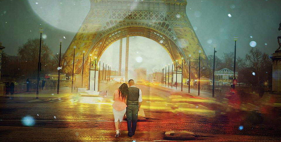 Couple walking hand-in-hand under the Eiffel Tower at sunset.