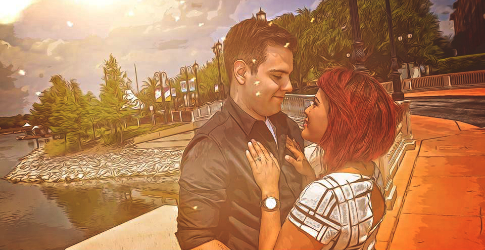Couple enjoying a tender moment outdoors near water.