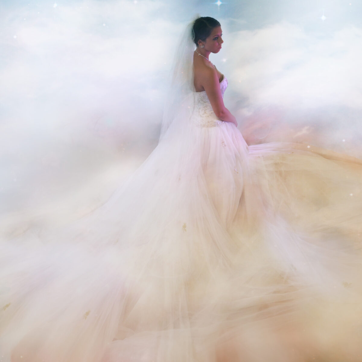A woman in a flowing, ethereal gown stands amidst soft clouds.