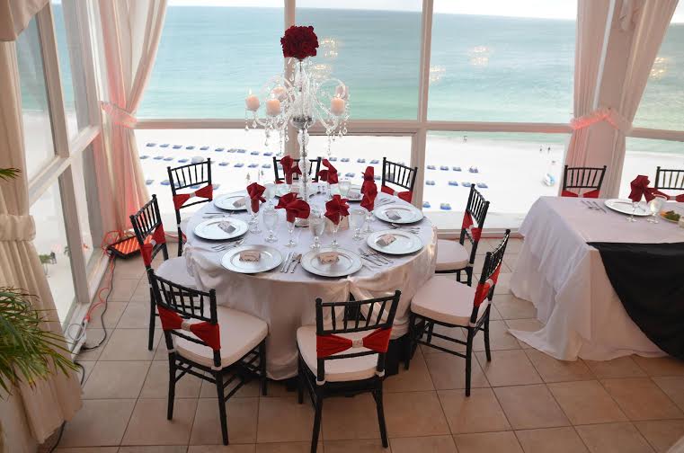 Elegant round table set for a meal with a sea view.